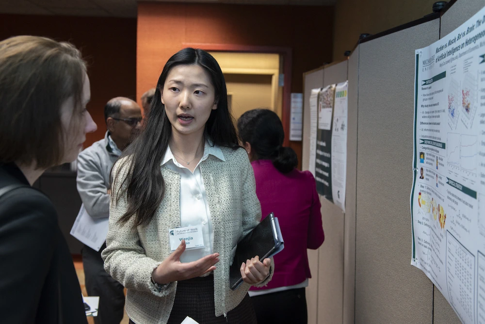 Wenjia Cao, economics doctoral student, won the poster competition. Following the program, students presented their research to a team of judges and conference attendees.