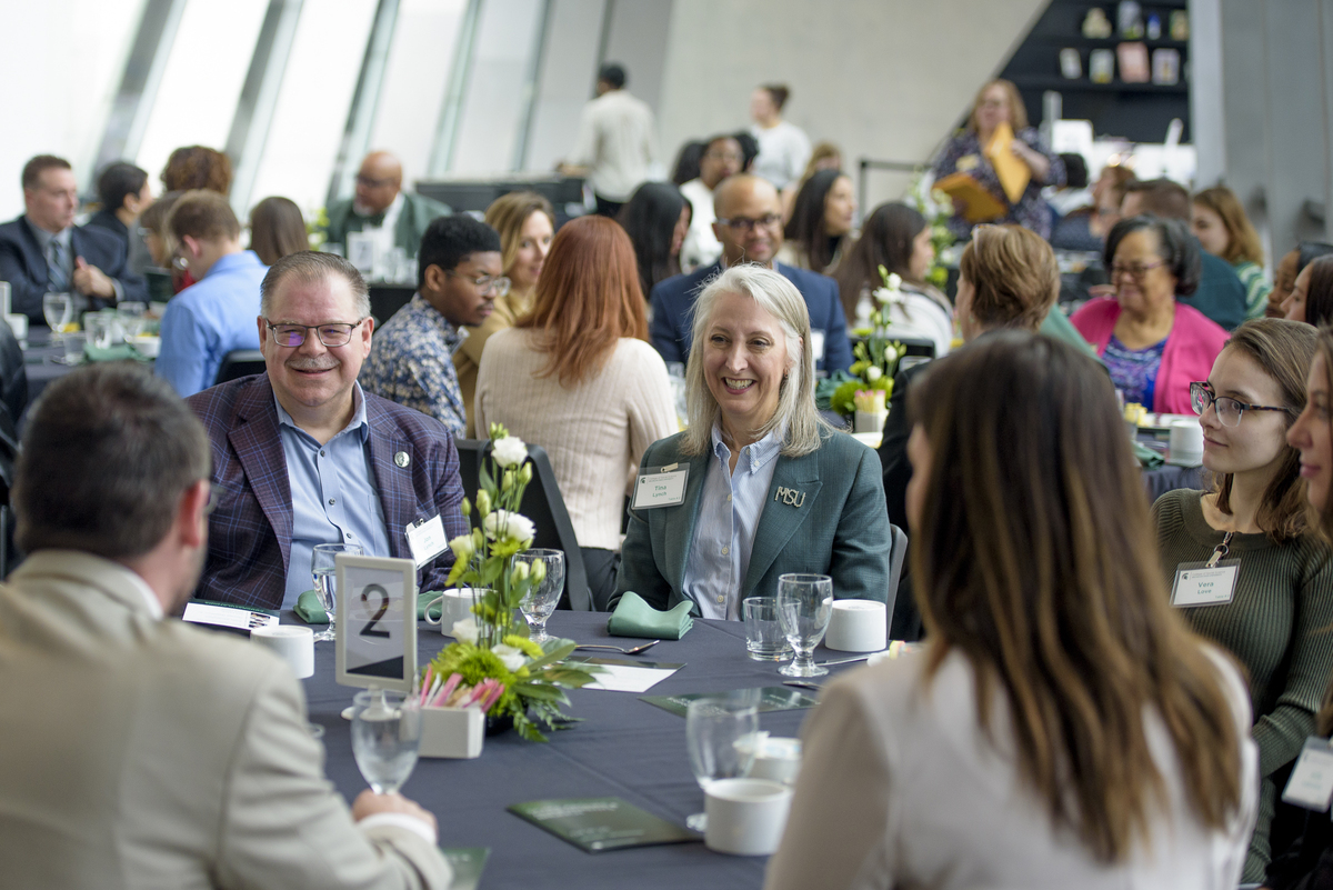 Jon & Tina Lynch speak with students at the College of Social Science scholarship brunch this past spring. 